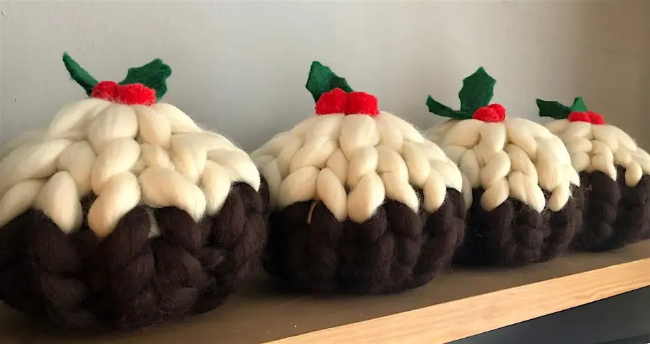 A collection of knitted objects in the shape of a Christmas pudding